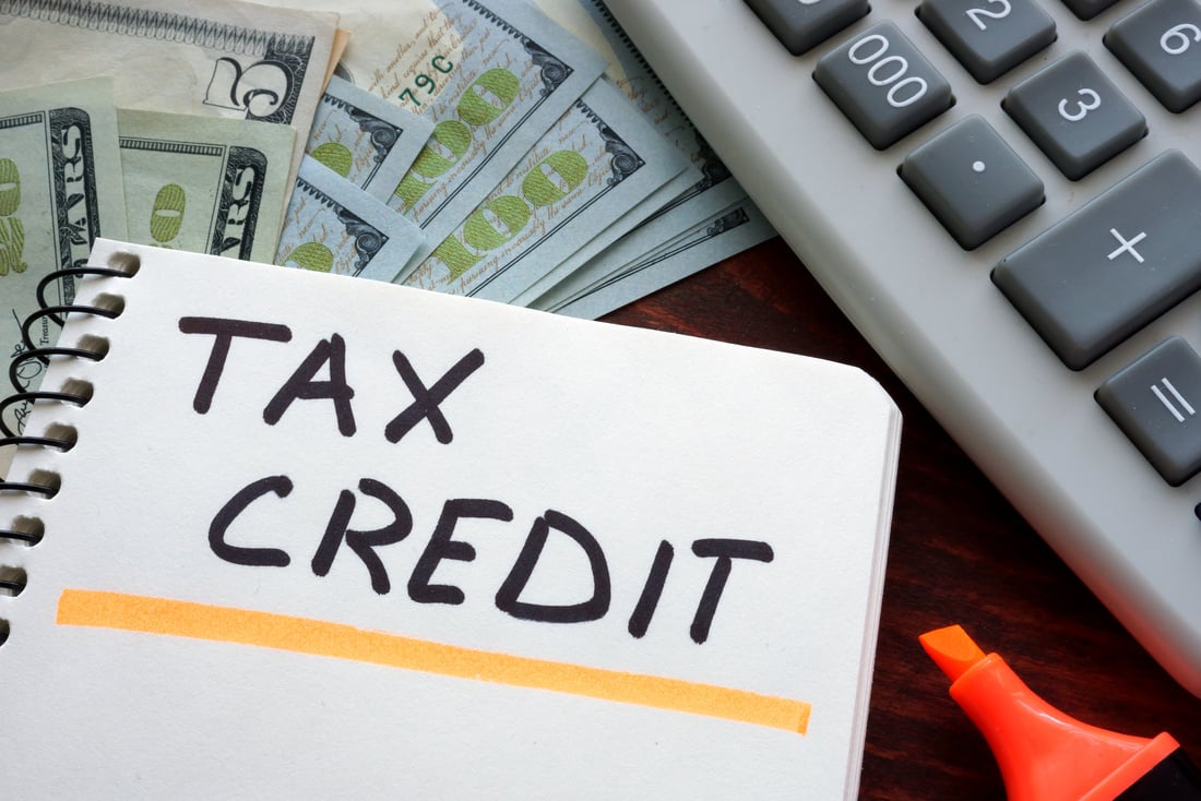 Notebook with tax credit  sign on a table. Business concept.